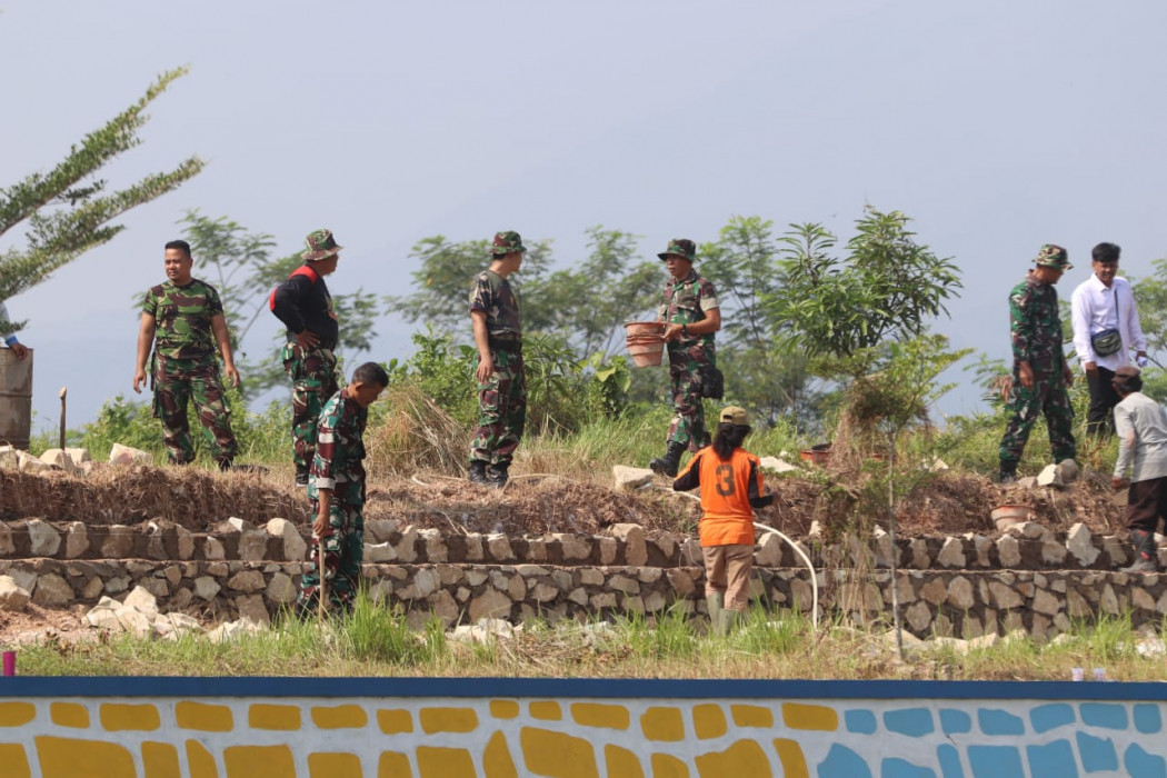 Caption : Anggota TNI Kodim 0620 bergotong royong dengan masyarakat Desa Kedongdong Kidul saat memperbaiki Infrastruktur desa. Foto : Ist
